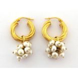 A pair of 9 carat gold and cultured pearl ear hoops, each small hoop suspended with a bunch of small
