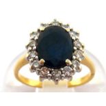 A sapphire and diamond cluster ring, the central oval cut stone 8.2 x 6.1mm, in a surround of