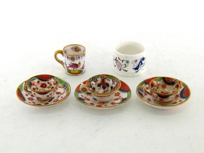 Three 19th. century miniature cups and saucers in the Crown Derby palette, unmarked apart from one