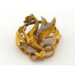 A French 18 carat gold and diamond brooch, modelled as a dragon rampant, the wings bordered with a