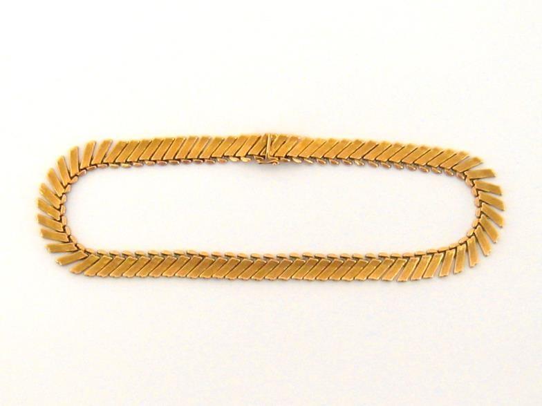 A yellow metal (tests 18 carat gold) fringe necklace, composed of obliquely set textured rectangular