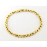 A French 18 carat gold and diamond collar, the tightly scrolling links set to the front with eight