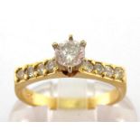 A diamond ring, the central stone approx. 0.30 carat, in a high claw set mount, above brilliant