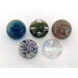 Five modern glass paperweights, being two swirl pattern, blue/green and white/pink, two volcano