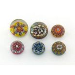 A collection of six small millefiori paperweights, largest 5cm. across