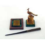 A gilt bronze inkwell on square malachite base, the short ribbed column with blue glass liner and