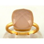 A rose quartz dress ring, in the style of Pomellato, the facetted cushion shaped stone 10.3mm, the