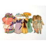 A collection of four early 20th. century card child dolls with about 22 fold over dressing up tab