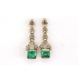 A fine pair of Art Deco emerald and diamond earrings, each drop set with an emerald cut stone, 3.3