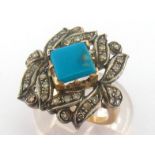 A turquoise and diamond plaque ring, the square claw set turquoise stone in an open work single