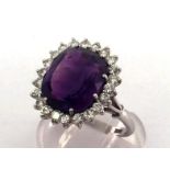 An amethyst and diamond cluster ring, the large rectangular mixed cut stone 13 x 11.2mm, in a