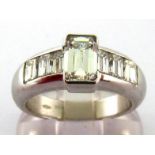 A fine diamond dress ring, the central emerald cut stone approx. 1.10 carats, rub over set above