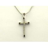 A diamond and sapphire cross pendant, the articulated white gold mount pave set with small