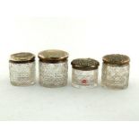 Four silver topped cut glass toilet jars, each hobnail-cut, three with star-cut bases (4). Generally
