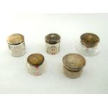 Five various silver-topped cut-glass toilet jars, comprising one panel-cut, two wheel-engraved,