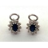 A pair of sapphire and diamond cluster ear clips, the central oval cut sapphires 6 x 4mm, in a