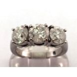 An 18 carat white gold and three stone diamond ring, the three brilliants totalling approx. 3