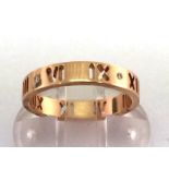 Tiffany & Co, an Atlas Collection 18 carat gold and diamond band ring, cut with Roman numerals about