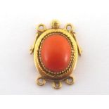 A mid 20th century 18 carat gold and coral set clasp, the domed oval red coral cabochon 3.2cm
