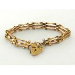 A 9 carat gold gate link bracelet, to a heart shaped padlock clasp, fully hallmarked, with safety
