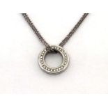 BOODLES, an 18 carat white gold and diamond small 'Roulette' pendant, the circle pave set with small