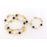 A South Sea three colour cultured pearl necklace, composed of 13-15mm golden, silver and black round