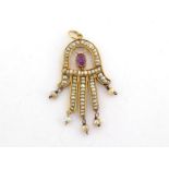 A seed pearl and ruby 'Hand of Fatimah' pendant, the yellow mount stamped '585', 4cm long, 3.6gms