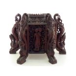 A large and impressive Burmese teak hexagonal stand, each face with a dancing or attendant figure