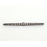 A rose cut diamond bar brooch, set along its length with graduated irregular shaped stones,