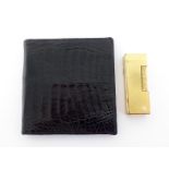Dunhill, a gold plated lighter, with engine turn design, 6.3cm long, together with a black leather