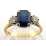 An 18 carat gold, sapphire and diamond ring, the central emerald cut sapphire approx. 1.8 carat,