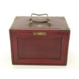 A vintage bone and bamboo mah jong set in brass bound hardwood cabinet with double carrying handle