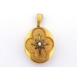 A late Victorian gold, enamel and pearl locket, the oval locket finely chased with arabesque