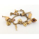 A 9 carat gold curb link charm bracelet, suspended with thirteen gold charms, seven fully