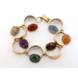 A 1960s Modernist hardstone set bracelet, the openwork circular links set with high domed cabochon