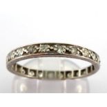 A diamond eternity ring, set with small single cuts, mounted in white metal (tests platinum), finger