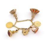 A 9 carat gold curb link bracelet, suspended with four 19th century carnelian intaglio fob seals,