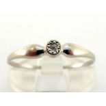 A French 18 carat white gold and diamond ring, set to the centre wiht a small illusion set sonte,