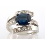 A sapphire and diamond dress ring, the rectangular cushion cut stone 7.8 x 9.3mm, the three