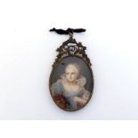 A 19th. century oval miniature of a young girl in 18th. century French costume in a gilt metal