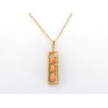 A yellow metal coral pendant, marked 14k, 2.3 gms