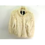 A Lady's white fur coat with black lining in as new condition, size medium