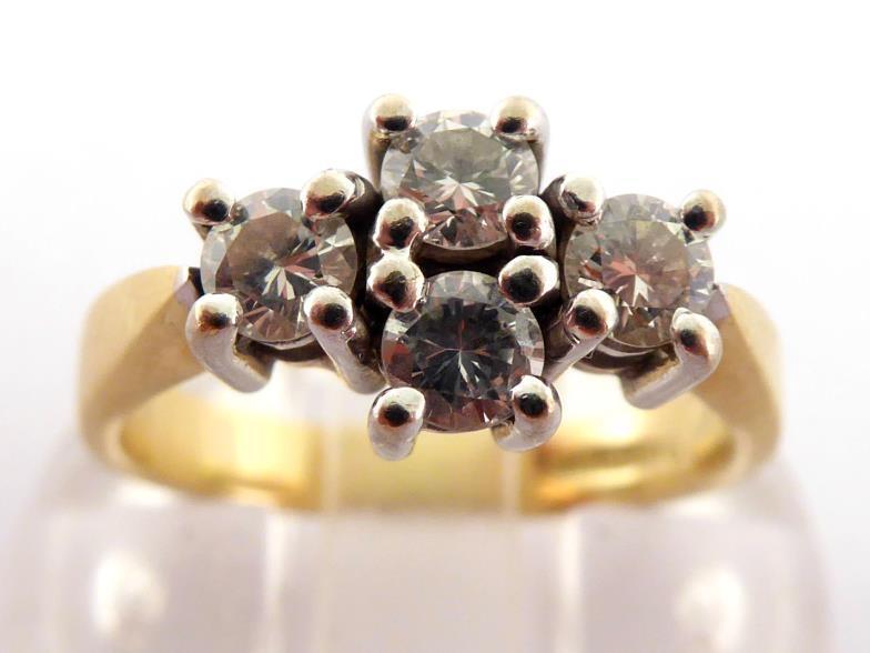 An 18 carat gold and diamond four stone ring, the cluster of four brilliants totalling approx. 0.