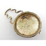 A George III silver lemon strainer by Edward Aldridge, London, 1771, with shaped foliate scroll