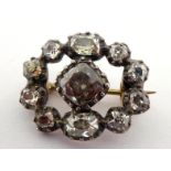 A 19th century diamond brooch, composed of an oval of cushion cuts stone, the largest at the centre,