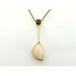 A brown zircon and opal pendant, the large triangular opal 28mm long, spectacle set, with blade