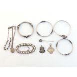 A mixed lot of silver and white metal jewellery, including a locket, stamped 'STERLING SILVER'; a