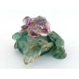 A Chinese multi-colour fluorite carving of a water pot, decorated with fruit and leaf around the