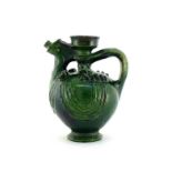 A green glazed ceramic water pot or aquamanile with simple stylised decoration of a bird, with