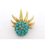 A diamond and turquoise brooch, the cluster of turquoise beads with a brilliant cut to the centre,
